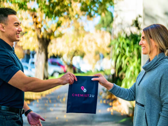 Courier delivering a package to a residential home.