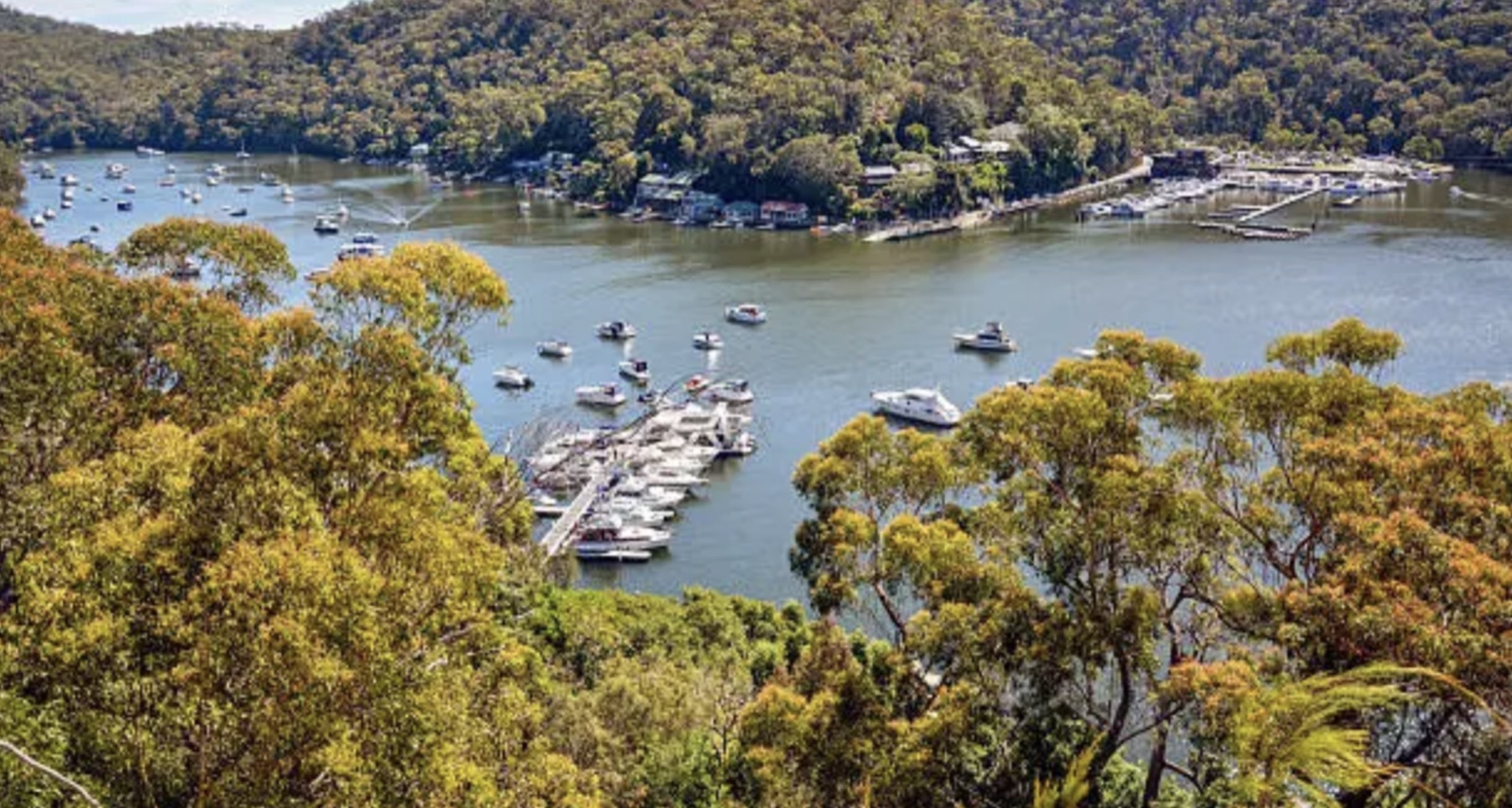 Berowra Waters marina and boat moorings in the Hornsby Shire, framed by bushland on the Upper North Shore