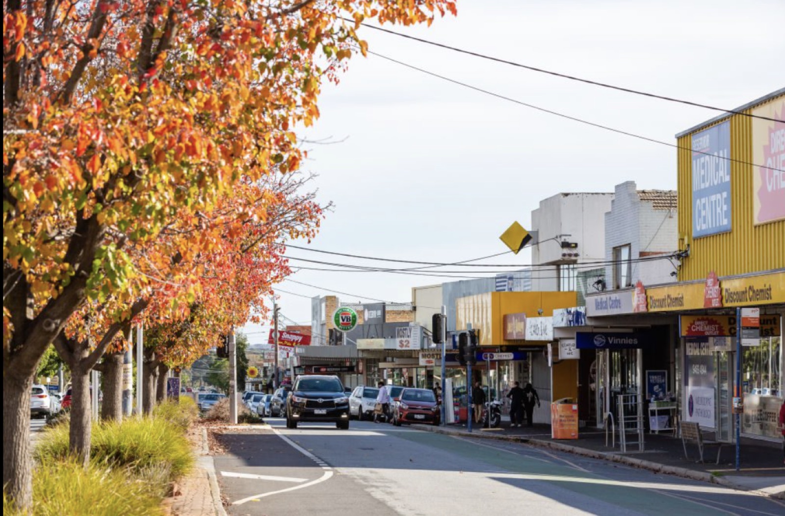 Broadway shopping strip in Reservoir with autumn trees