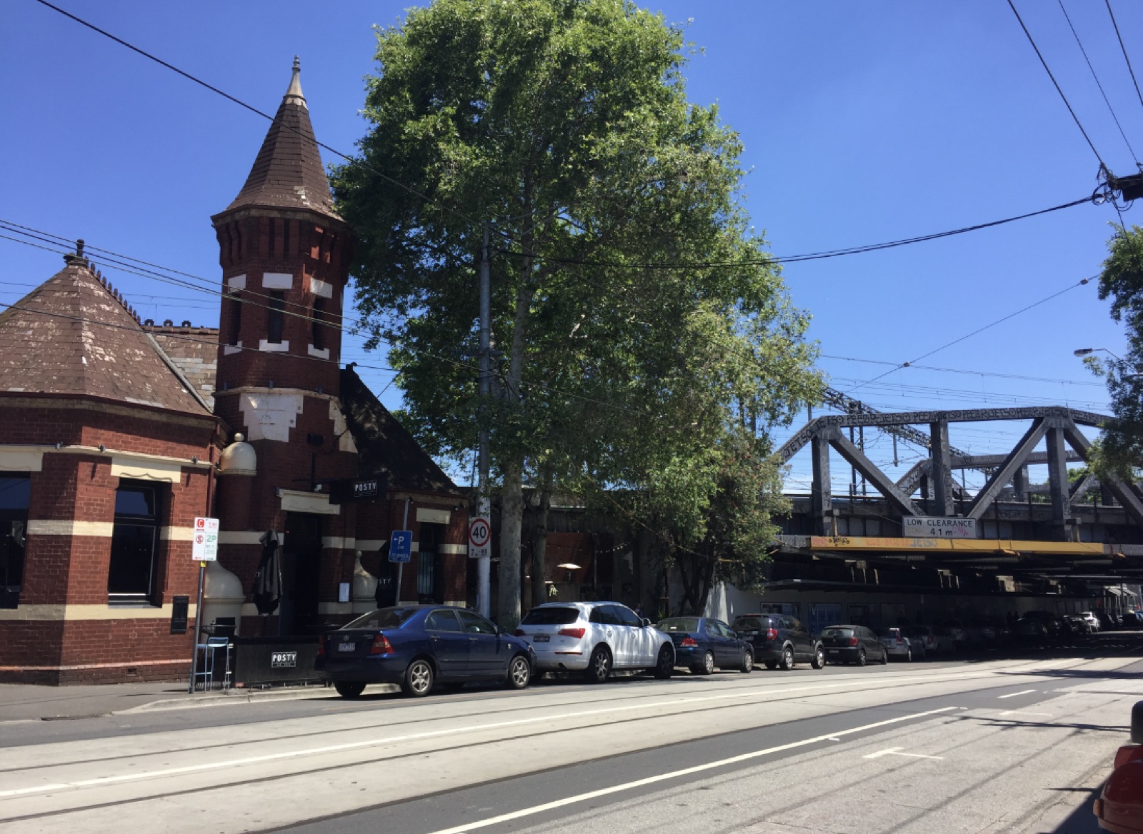 Richmond streetscape with heritage brick facade and rail bridge