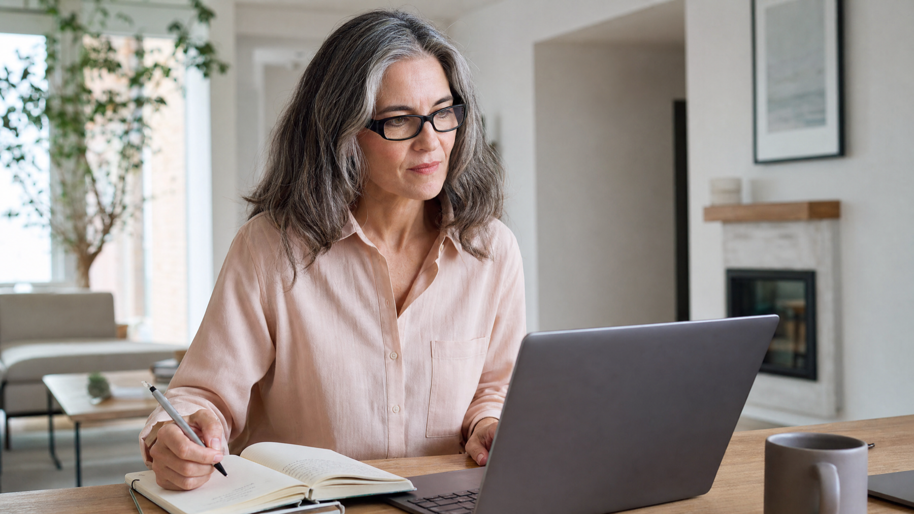 Australian woman preparing notes at her desk before a telehealth menopause consultation