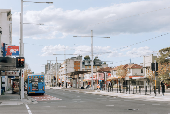 Anzac Parade with the L2 light rail line and bus, Kensington NSW 2033